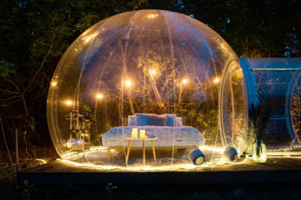 una bubble room illuminata con dentro il letto di notte
